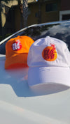 Damage white dad hat with red and orange logo .